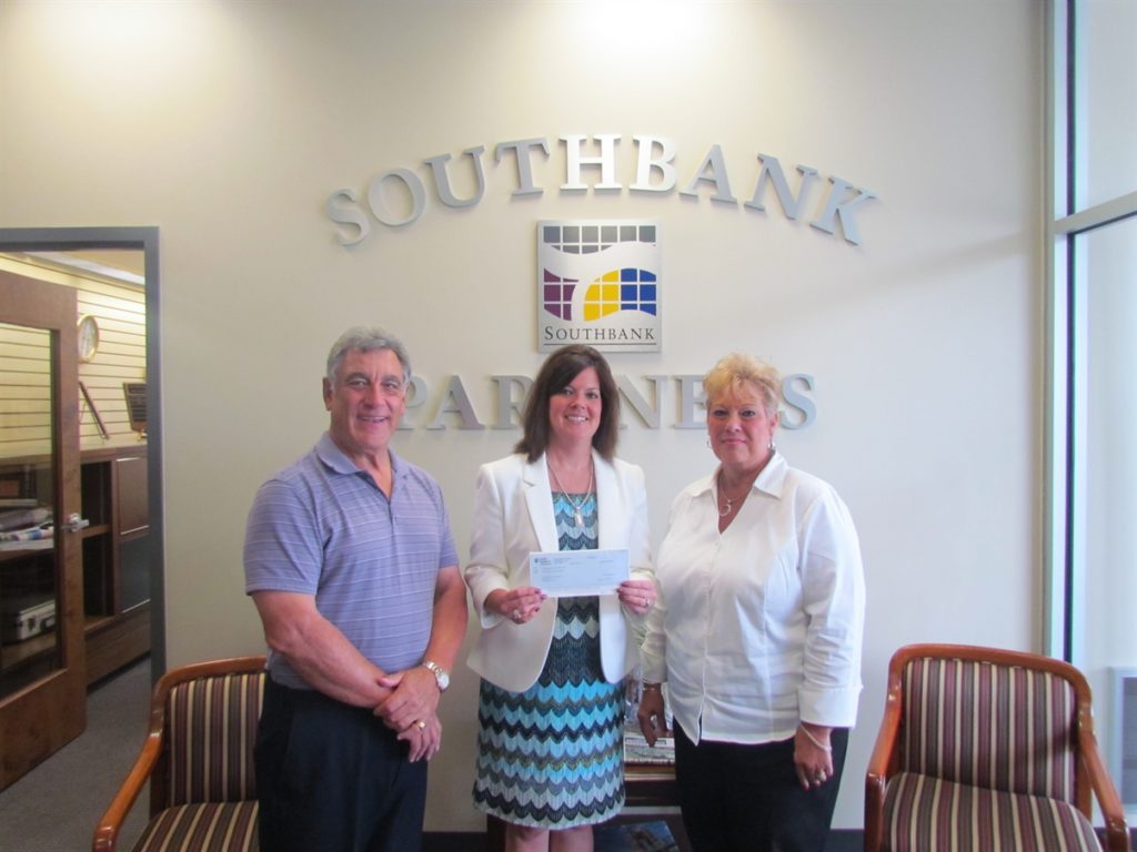 Jack Moreland and Joyce McMullin receiving a check from Duke Energy